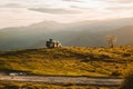 Back view of a Spanish man and a dog admiring nature while sitting on a camper van parked on a hill Royalty Free Stock Photo