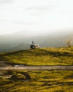 Back view of a Spanish man and a dog admiring nature while standing on a camper van parked on a hill Royalty Free Stock Photo