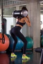 back view of sport woman in sportswear exercise squat with training  lifting weight bag in fitness gym . young girl workout . Royalty Free Stock Photo