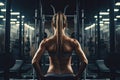 Back view of sporty woman with tattoos on her back standing in gym, Women doing battle workouts with rope in a gym, top section Royalty Free Stock Photo