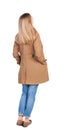 Back view of standing young beautiful blonde woman in brown clo Royalty Free Stock Photo