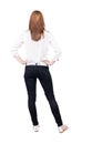 Back view of standing young beautiful blonde woman in jeans. Royalty Free Stock Photo