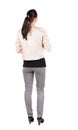 Back view of standing young beautiful brunette woman. Royalty Free Stock Photo