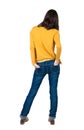 Back view of standing young beautiful brunette woman in yellow Royalty Free Stock Photo