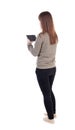 Back view of standing young beautiful girl with tablet computer Royalty Free Stock Photo