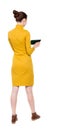 Back view of standing young beautiful girl with tablet computer Royalty Free Stock Photo