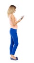 Back view of standing young beautiful girl with tablet computer Royalty Free Stock Photo