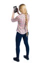 Back view of standing young beautiful girl with tablet computer in the hands of Royalty Free Stock Photo