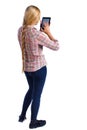 Back view of standing young beautiful girl with tablet computer in the hands of. Royalty Free Stock Photo