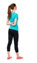 Back view of standing young beautiful woman. girl watching. Royalty Free Stock Photo