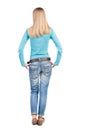 Back view of standing young beautiful woman in jeans. Royalty Free Stock Photo