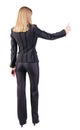 Back view of standing young blonde business woman showing thumb Royalty Free Stock Photo