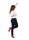 Back view of standing young redhead business woman showing thumb Royalty Free Stock Photo