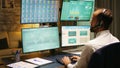 Back view of stock market trader looking at graphs Royalty Free Stock Photo