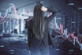 Back view of stressed out businesswoman looking at abstract downward forex chart on blurry office interior background. Crisis, Royalty Free Stock Photo