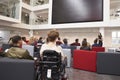 Back view of students at a lecture in a university atrium Royalty Free Stock Photo