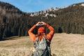 Back view of stylish Woman in red hat with backpack hiking in woods. Freedom and active lifestyle concept. Adventure Royalty Free Stock Photo