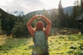 Back view of stylish Woman in red hat with backpack hiking in woods. Freedom and active lifestyle concept. Adventure Royalty Free Stock Photo