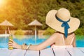 Young adult woman female relaxing on resort near pool in summer Royalty Free Stock Photo