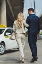 back view of stylish young couple going together to Royalty Free Stock Photo