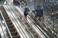 Stylish young man going up by escalator. Royalty Free Stock Photo