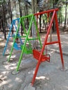 Back view of swing in the garden, empty swings in the playground, colorful swings in the park