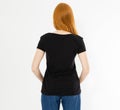 Back view t-shirt design, happy people concept - smiling red hair woman in blank black t-shirt pointing her fingers at herself, Royalty Free Stock Photo