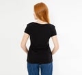 Back view t-shirt design, happy people concept - smiling red hair woman in blank black t-shirt pointing her fingers at herself, Royalty Free Stock Photo