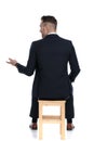 Back view of a talking businessman gesturing and sitting