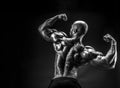 Back view of tattoed bodybuilder with outstretched arms Royalty Free Stock Photo