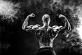 Back view of tattoed bodybuilder with outstretched arms Royalty Free Stock Photo