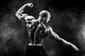 Back view of tattoed bodybuilder with outstretched arms Royalty Free Stock Photo