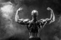 Back view of tattoed bodybuilder with outstretched arms Royalty Free Stock Photo