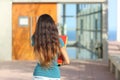 Back view of a teen girl walking towards the school