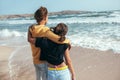 Back view of teenage boy and girl hugging and wathing the sea Royalty Free Stock Photo