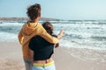 Back view of teenage boy and girl hugging and wathing the sea Royalty Free Stock Photo