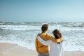 Back view of teenage boy and girl hugging and wathing the sea Royalty Free Stock Photo