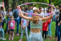 Girl in beautiful dress performs with hula hoops