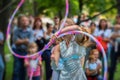 Girl in beautiful dress performs with hula hoops