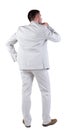 Back view of thinking young business man in white suit. Royalty Free Stock Photo