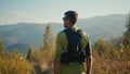 Back view thoughtful calm adult Caucasian male man guy sportsman mountaineer athlete rest hiking looking around enjoy Royalty Free Stock Photo