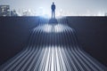 Back view of thoughtful young businessman standing on abstract wave staircase on city background. Career, success and growth Royalty Free Stock Photo