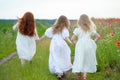 back view of three little girls wearing white dress running together joined hands outdoors Royalty Free Stock Photo