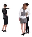 Back view of three young business woman pointing