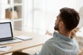 Back view of tired male falling asleep at workplace Royalty Free Stock Photo