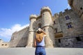 Back view of tourist girl visiting the Palace of the Grand Master of the Knights of Rhodes, Greece Royalty Free Stock Photo