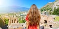 Back view tourist woman in Greek theater of Taormina with Etna volcano on the background, Sicily, Italy. Panoramic banner view Royalty Free Stock Photo