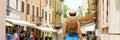 Back view of tourist woman with hat Peschiera del Garda old town in Italy. Panoramic banner view