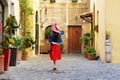 Back view of tourist woman holding hat at Trastevere in Rome, Italy. Royalty Free Stock Photo