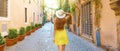 Back view of tourist woman holding hat at Trastevere in Rome, Italy. Panoramic banner view Royalty Free Stock Photo